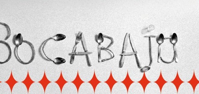 Bocabajo: la palabra Bocabajo formada con cubiertos sobre una pared blanca.